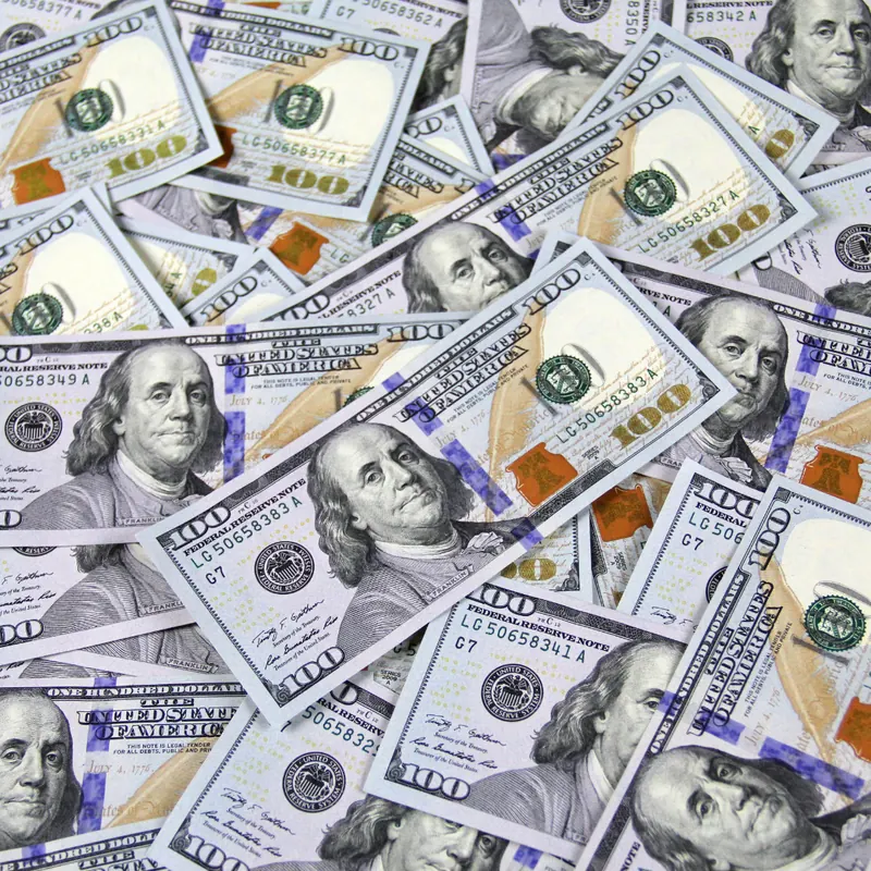 Stack of hundred dollar bills representing a cash home sale